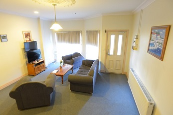 living room with blue sofa and chairs