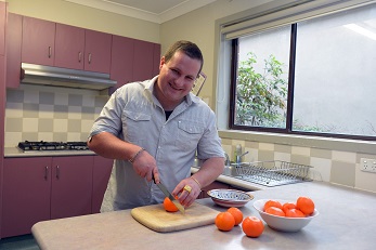 man cutting oranges