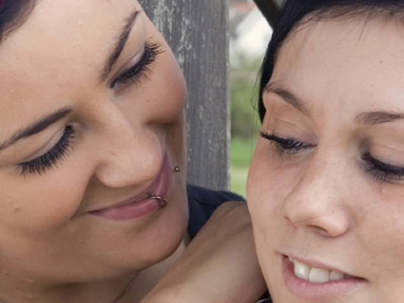 Two young women happy together