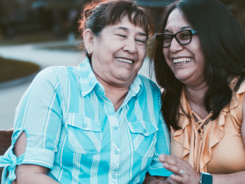 Two women embracing and laughing