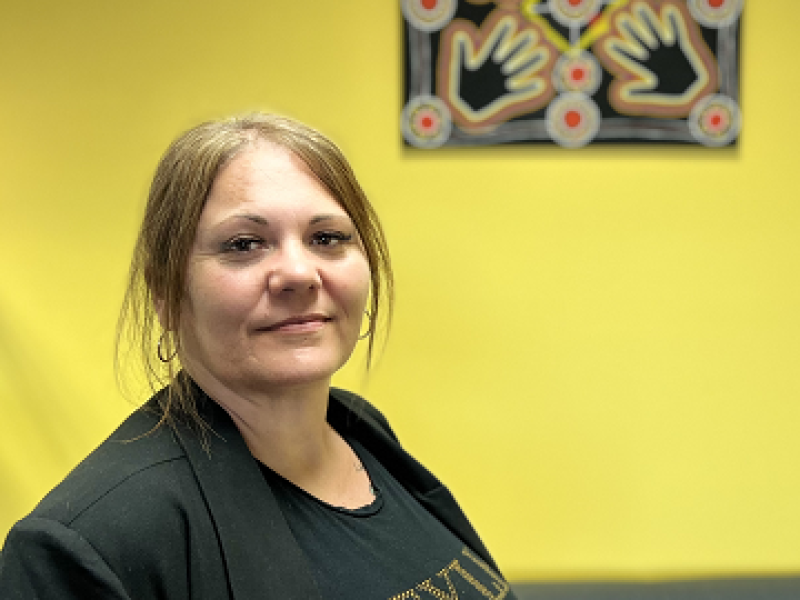 Woman smiling with yellow wall backdrop