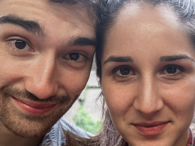 a young man and a young woman standing close together