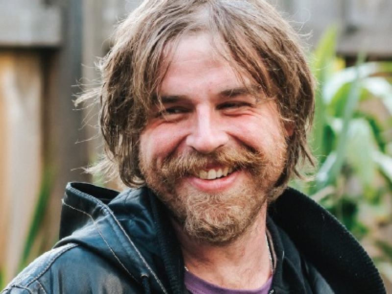 Man smiling in backyard