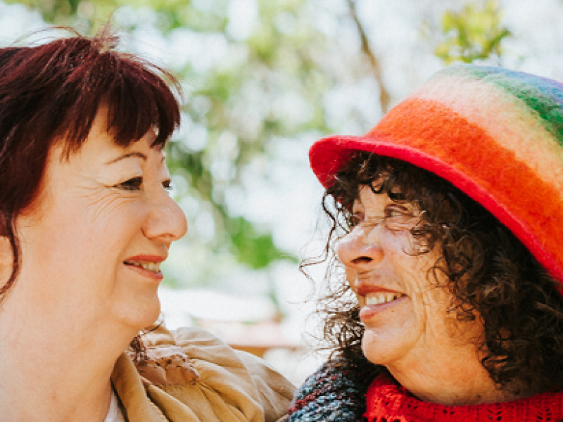 two woman smiling at each other