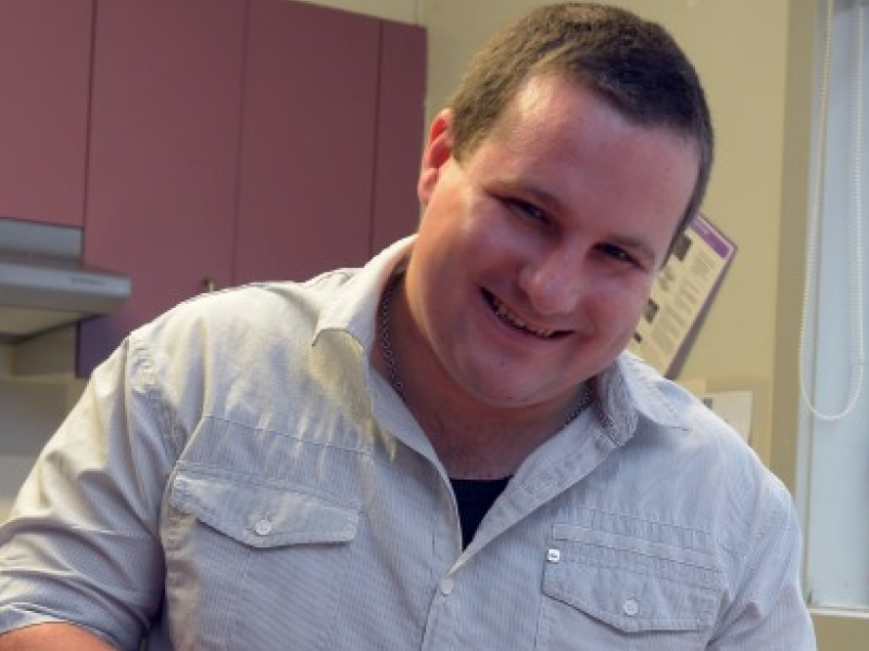 Man in kitchen smiling