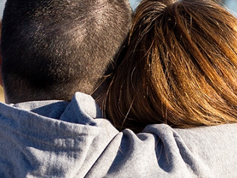 Man holding woman - shot from back