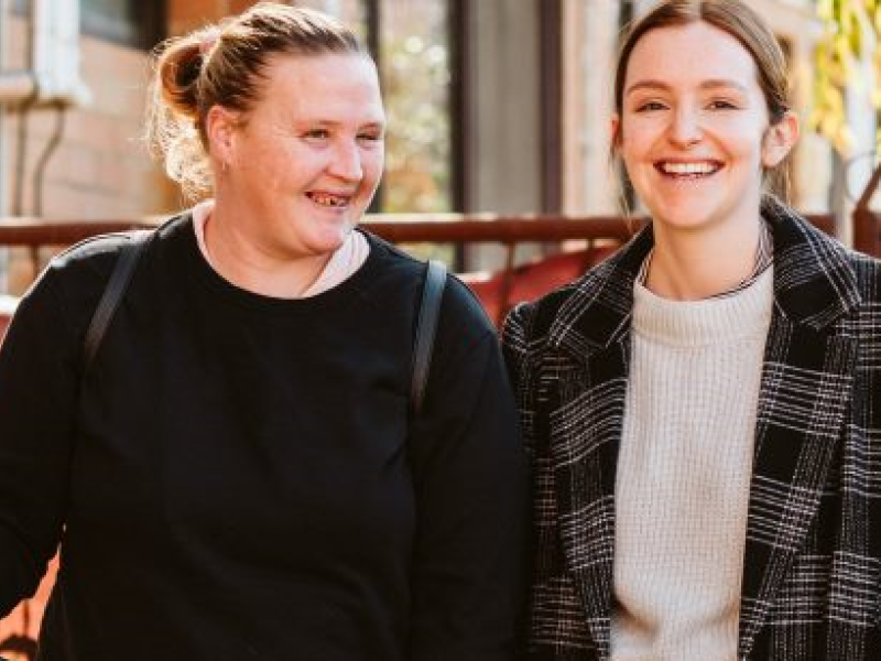 two women walking and laughing