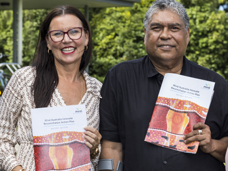 woman and a man holding a document - Mind Australia's Innovate Reconciliation Action Plan