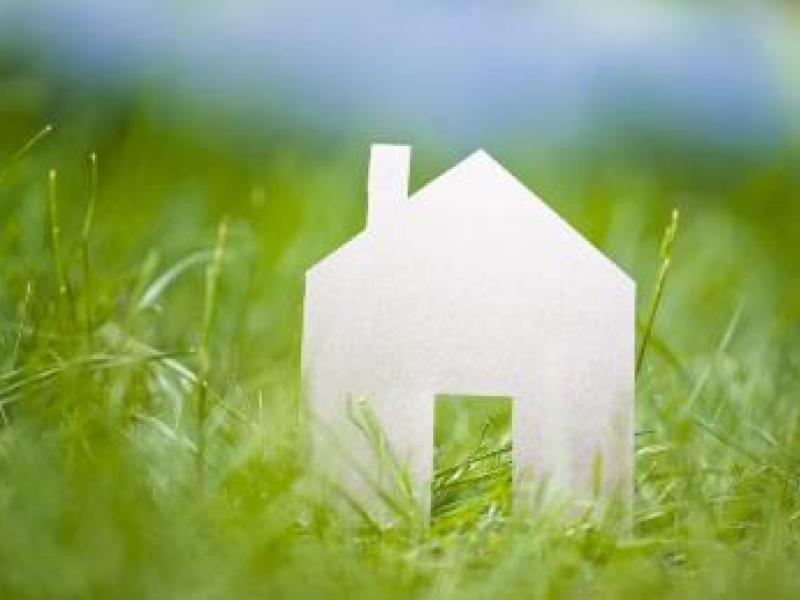 Paper house front in grass