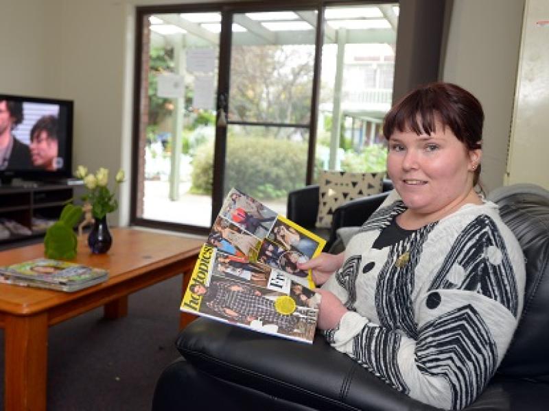 Woman reading a magazine in the living room at Williamstown residence