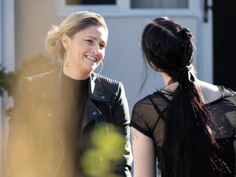 Two women chatting outside