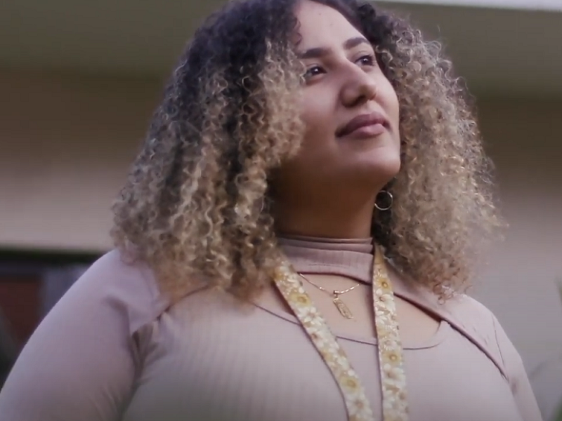 Woman of color looking away confidently