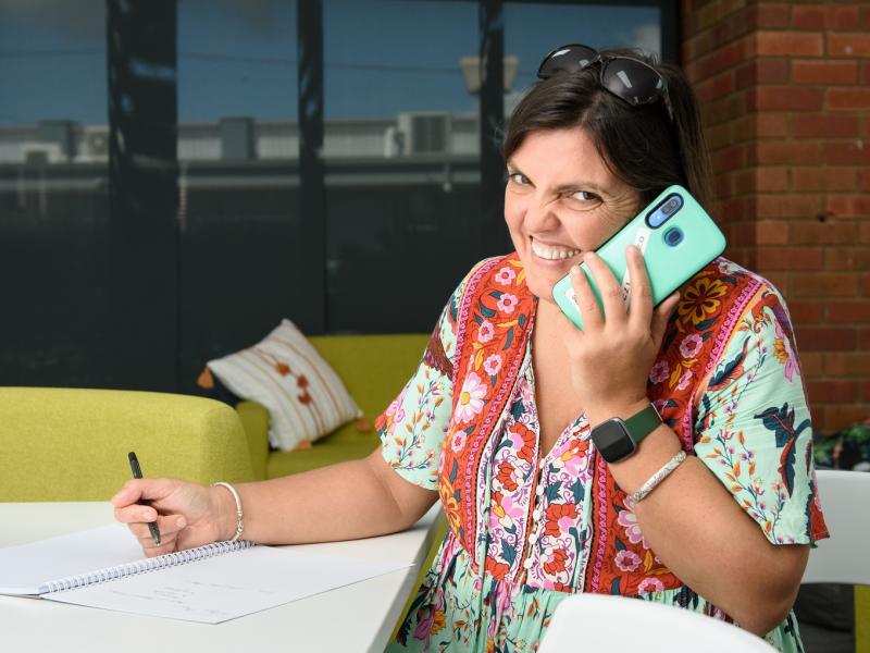 Woman holding a smartphone to her ear and smiling