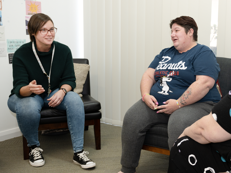 Three women chatting in a therapy session