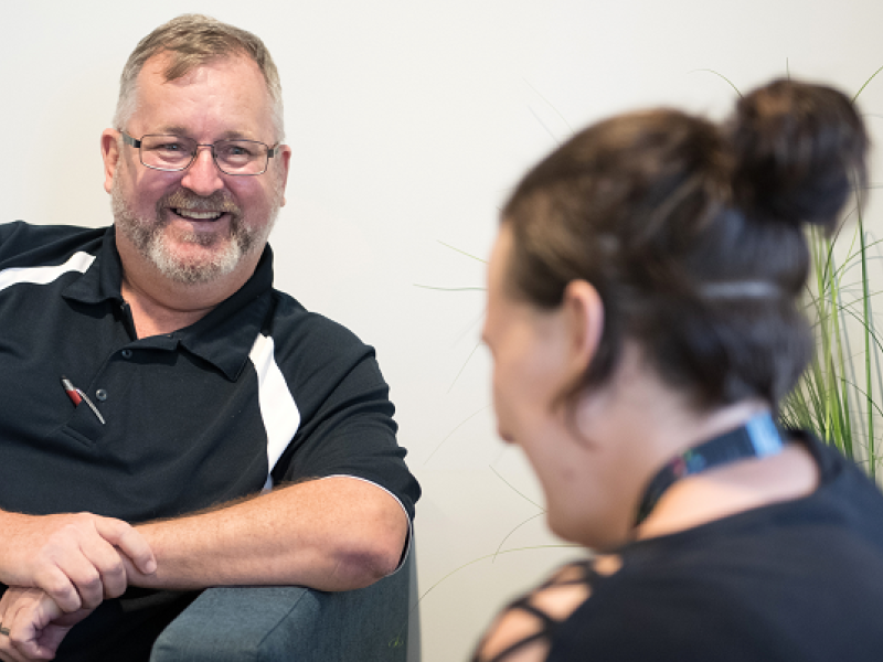 Man chatting with woman listening