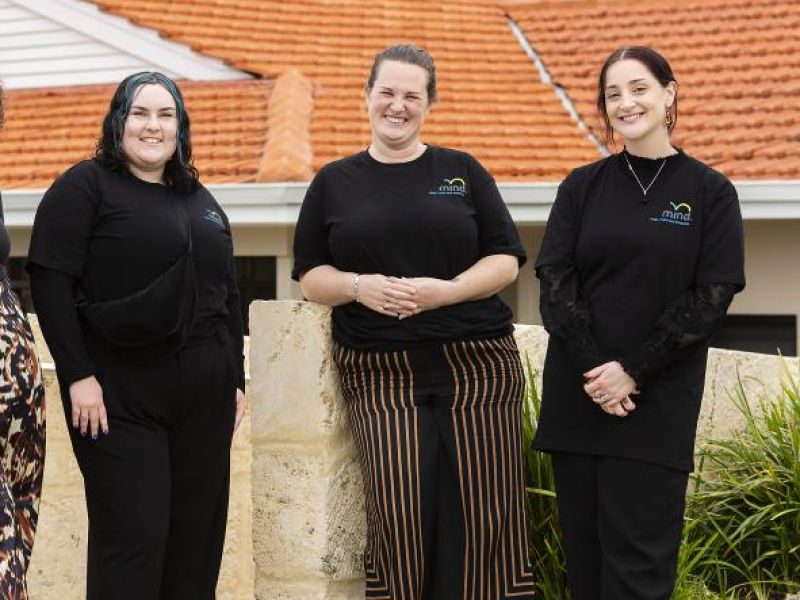 3 Women standing in front of a wall