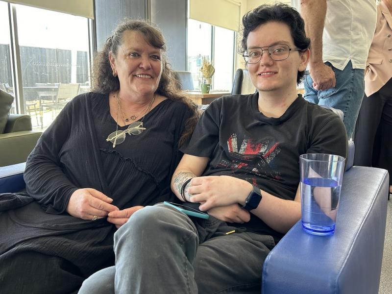 Two people sitting smiling