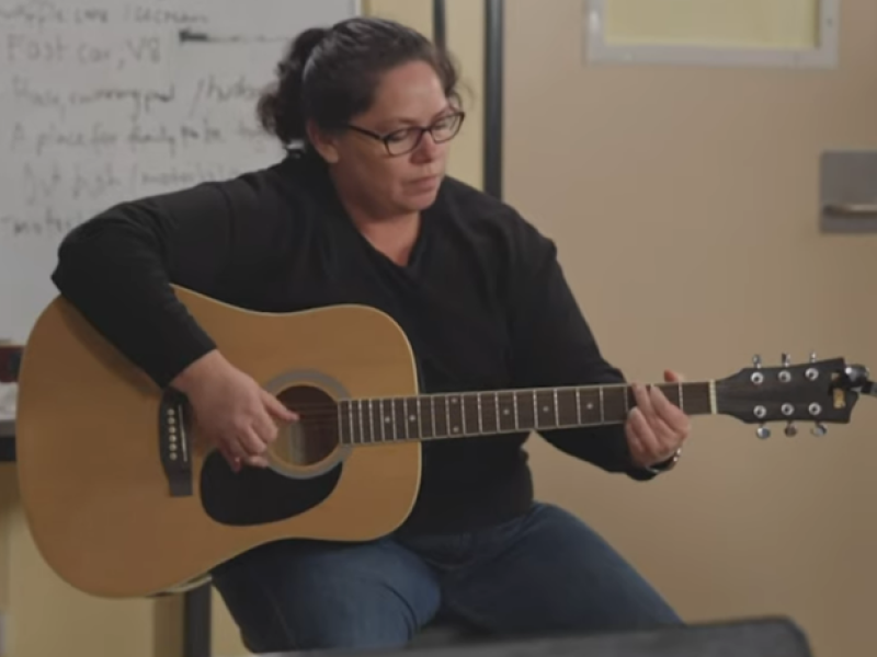 Nancy Bates playing the guitar