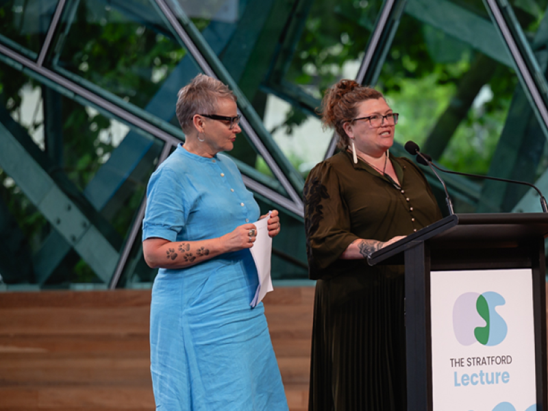 Two women standing at a lectern