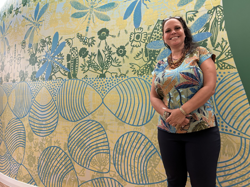 A woman standing with the painted wall