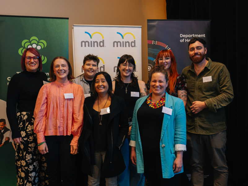 8 people standing and smiling