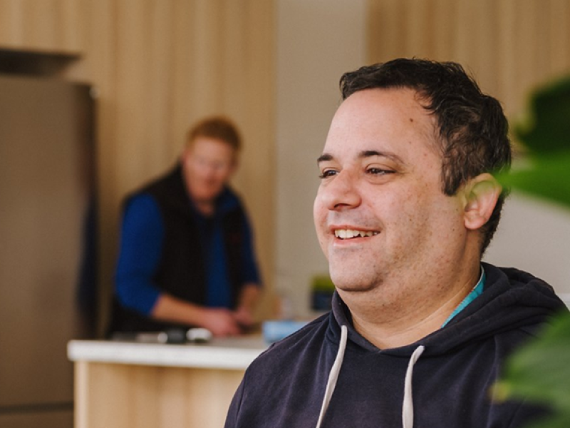 A man smiling at a table