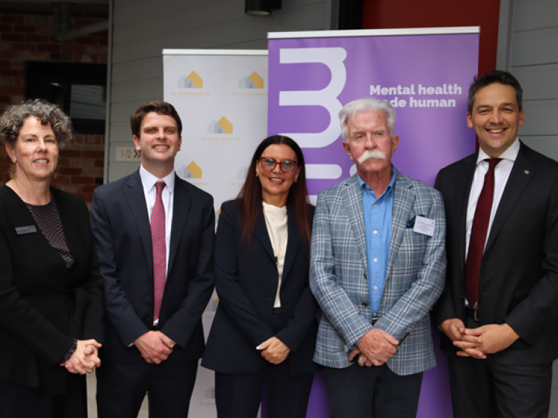 5 people standing and smiling