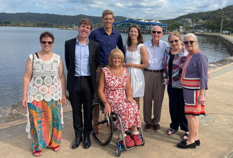 group of people standing on the foreshore