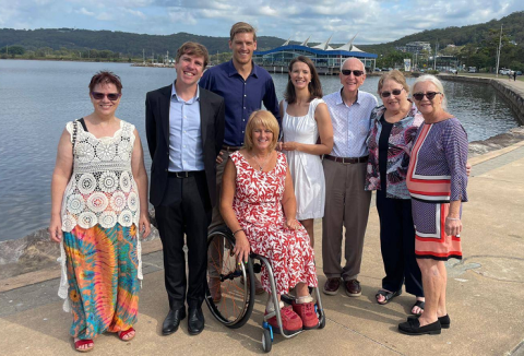 group of people standing on the foreshore 