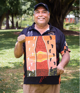 Stephen Oliver holding his art work