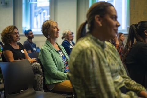 An audience listing and enjoying a conference