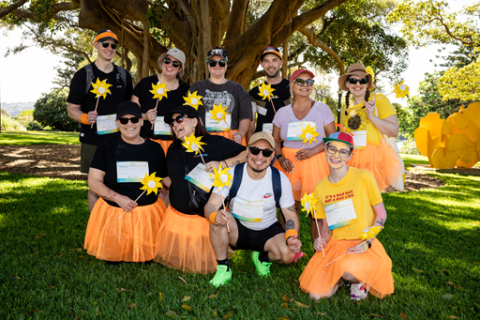 A group of Wellness Walk participants wearing orange and black