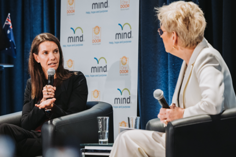 Two women chatting on stage