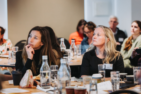 Two women listening in the audience