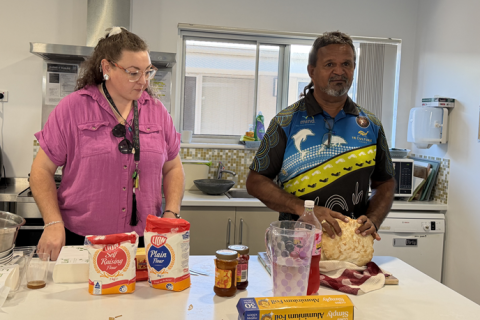 A man and woman in a kitchen baking